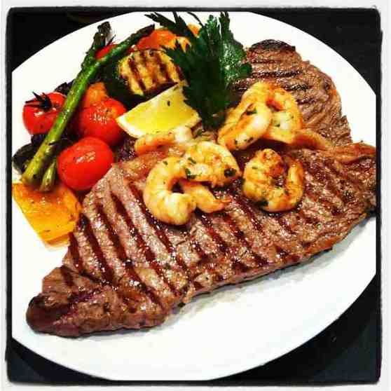 Happy Friday lunch. Andy's Surf & Turf. Scottish Sirloin & Rib Eye topped with marinated Tiger Prawns with a side of Mediterranean Roast Veg.